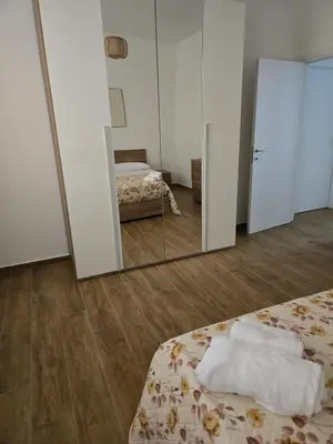 a room with a mirror and a bed and a bed sidx sidx sidx at Nonna Franca GuestHouse in Isola delle Femmine