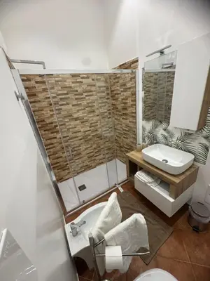 a bathroom with a shower and a sink and a toilet at Dimora Solemar-Mareluna village in Campofelice di Roccella
