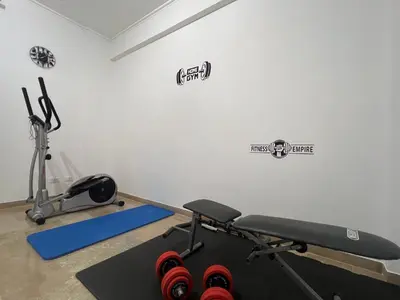 a room with a gym with a treadmill and weights at TramQuility House in Palermo