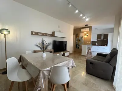 a dining room and living room with a table and chairs at TramQuility House in Palermo