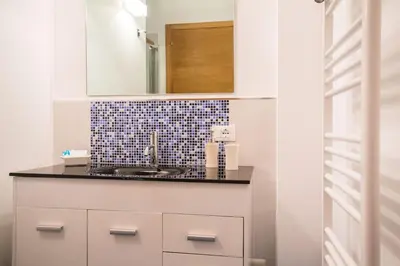a bathroom with a sink and a mirror at Mondello Suites FLH - Riflessi in Palermo