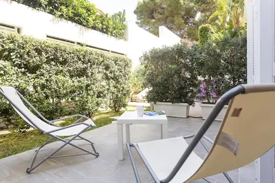 a patio with two chairs and a table on a patio at Mondello Suites FLH - Riflessi in Palermo
