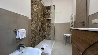 a bathroom with a shower and a sink and a sink at Albachiara Apartment vicino al mare di Capaci in Capaci