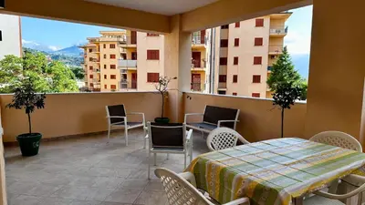 a balcony with a table and chairs and a view at Albachiara Apartment vicino al mare di Capaci in Capaci