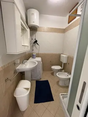 a bathroom with two toilets and a sink at Le Palme House in Isola delle Femmine