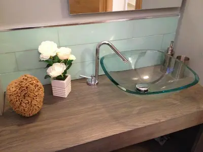 a glass sink on a counter in a bathroom at Mondello suites FLH - Posidonia in Palermo