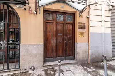 a wooden door on the side of a building at GuestHost - MiraVigghia Apartment in Palermo