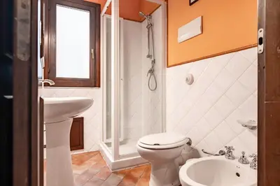 a white bathroom with a toilet and a sink at GuestHost - MiraVigghia Apartment in Palermo