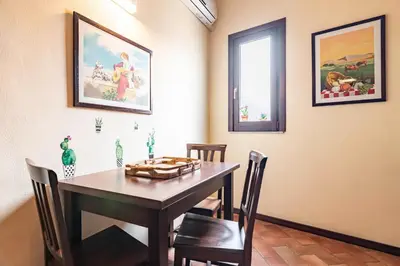 a dining room with a wooden table and chairs at GuestHost - MiraVigghia Apartment in Palermo