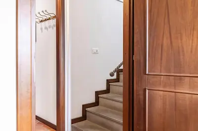 a hallway with a wooden door and stairs at GuestHost - MiraVigghia Apartment in Palermo