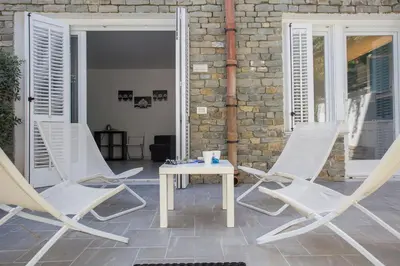 a group of chairs and a table on a patio at Mondello Suites FLH - Anemone in Palermo