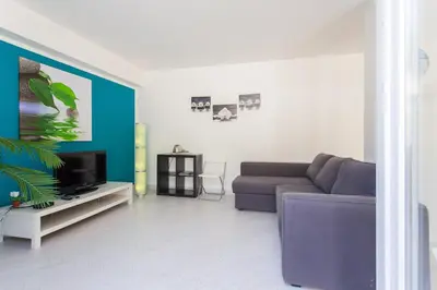 a living room with a couch and a tv at Mondello Suites FLH - Anemone in Palermo