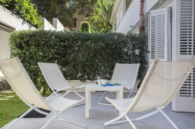 a group of chairs and a table on a patio at Mondello Suites FLH - Anemone in Palermo