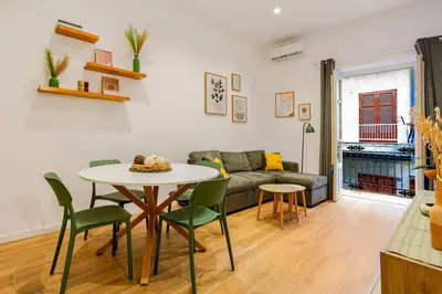 a living room with a table and a couch at Casa Vacanza Dante 17 Carini in Carini
