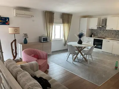 a living room with a couch and a table and chairs at villa naumachos in San Vito lo Capo