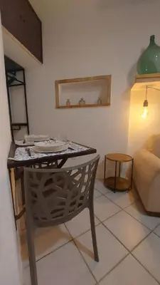a table and a chair in a living room at Casa dei normanni in Palermo