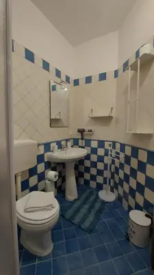 a bathroom with a toilet and a sink at Casa dei normanni in Palermo