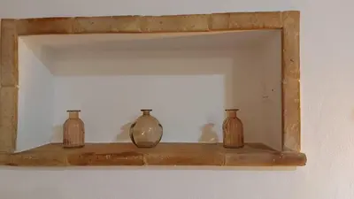 four glass vases sitting on a shelf in a room at Casa dei normanni in Palermo