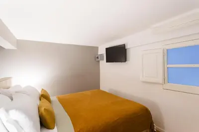 a bedroom with a bed and a window at Dimora Ai Leoni, Suite & Apartments in Palermo