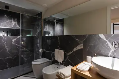 a bathroom with a sink and a toilet at Dimora Ai Leoni, Suite & Apartments in Palermo