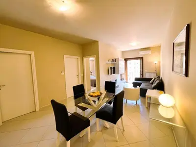 a dining room and living room with a table and chairs at Belmonte 18 in Palermo