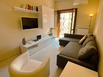 a living room with a couch and a tv at Belmonte 18 in Palermo