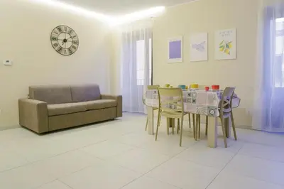 a living room with a couch and a table and chairs at CELSO E SAITTA per SAITTA HOLIDAYS in Palermo