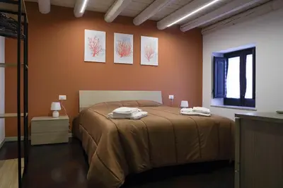 a bedroom with a bed with two towels on it at CELSO E SAITTA per SAITTA HOLIDAYS in Palermo