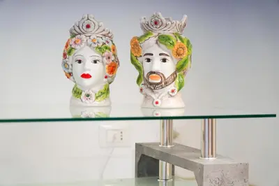 two vases sitting on top of a glass table at CELSO E SAITTA per SAITTA HOLIDAYS in Palermo