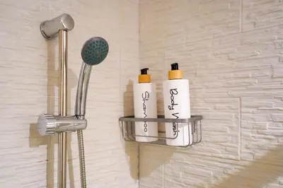 two shampoo bottles on a shelf in a bathroom at CELSO E SAITTA per SAITTA HOLIDAYS in Palermo