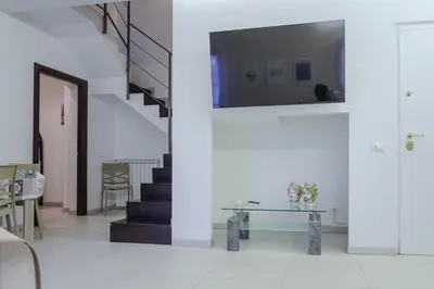 a room with stairs and a table and a stair case at CELSO E SAITTA per SAITTA HOLIDAYS in Palermo