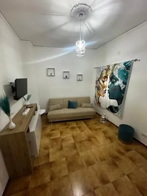 a living room with a couch and a tv at Casa vacanze I mori in Bagheria