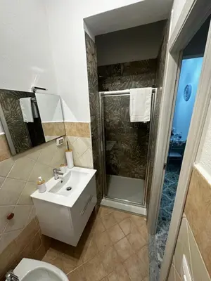 a bathroom with a toilet and a sink and a shower at Casa vacanze I mori in Bagheria