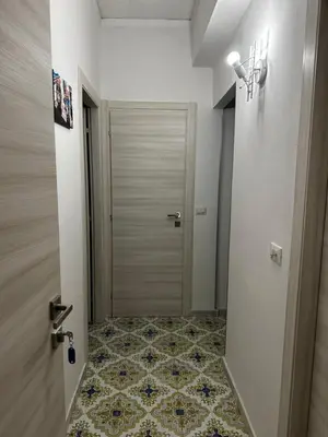 a hallway with a door and a tile floor at Casa vacanze I mori in Bagheria
