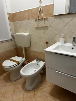 a bathroom with a toilet and a sink at Casa vacanze I mori in Bagheria