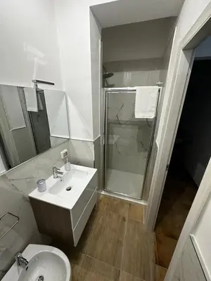 a white bathroom with a sink and a shower at Casa vacanze I mori in Bagheria