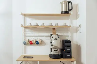 a kitchen with a coffee maker on a shelf at Casa Ru Vecchio Re in Palermo