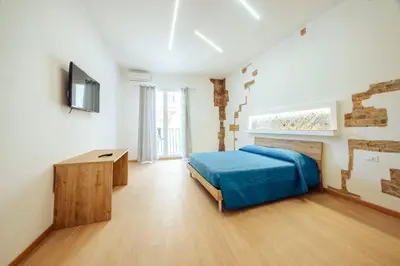 a bedroom with a bed and a television in it at Casa Ru Vecchio Re in Palermo