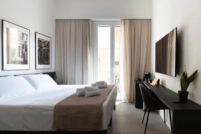 a bedroom with two white towels on a bed at Palermo Holiday House - Elegant Rooms near Politeama in Palermo