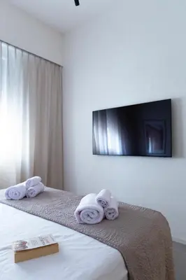 a bedroom with a bed and a table with a picture at Palermo Holiday House - Elegant Rooms near Politeama in Palermo
