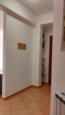 a room with white walls and a tile floor at Il mare negli occhi in Porticello