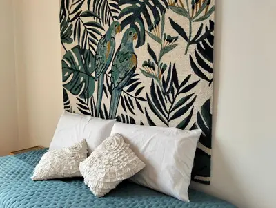 a bed with two pillows on it with a wall at Il mare negli occhi in Porticello
