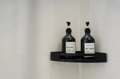 two bottles of wine on a shelf on a wall at Vincis Home in Palermo