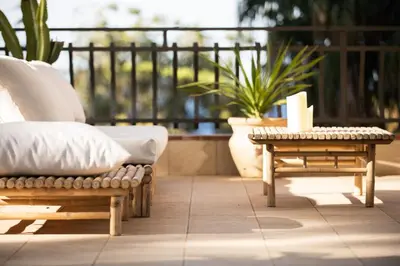 a patio with a couch and a table and plants at Villa Azzurra in Scopello
