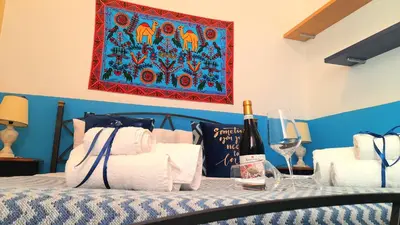 a bedroom with a bed with a table with wine glasses at House Via Napoli in Palermo