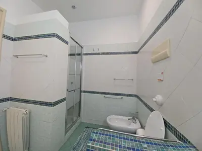 a bathroom with a toilet and a sink in it at House Via Napoli in Palermo