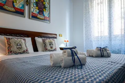 a stuffed teddy bear is laying on a bed at House Via Napoli in Palermo