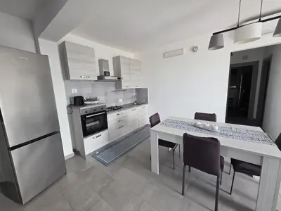 a kitchen with a table and chairs and a refrigerator at A Casa di Angela in Capaci