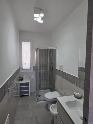 a bathroom with a shower and a toilet and a sink at A Casa di Angela in Capaci
