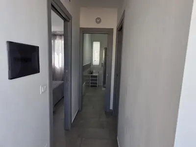 a hallway leading to a bathroom with a television at A Casa di Angela in Capaci